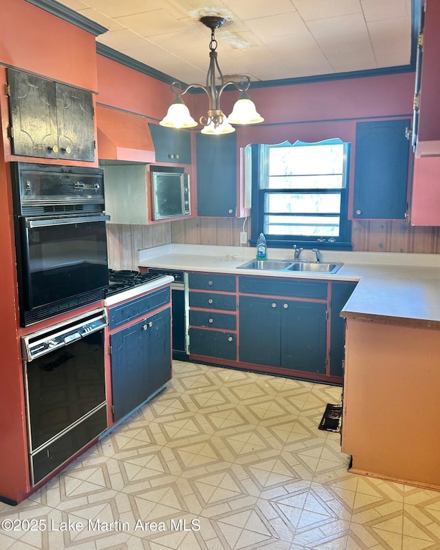 kitchen with light countertops, a sink, pendant lighting, light floors, and ornamental molding