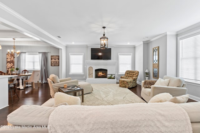 2409 Meadow Cove Rd, Auburn, AL 36832 - living area featuring a chandelier, dark wood finished floors, crown molding, a fireplace, and recessed lighting