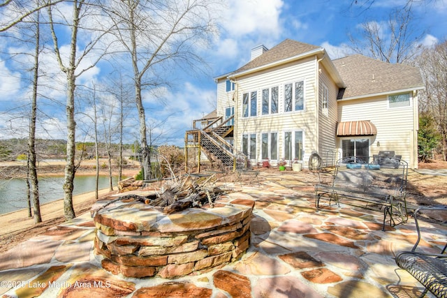 127 Ridge Crest Dr, Jacksons Gap, AL 36861 - rear view of property with stairway, a chimney, a patio, roof with shingles, and a deck with water view