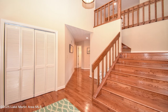 127 Ridge Crest Dr, Jacksons Gap, AL 36861 - stairs with wood finished floors, a high ceiling, and baseboards
