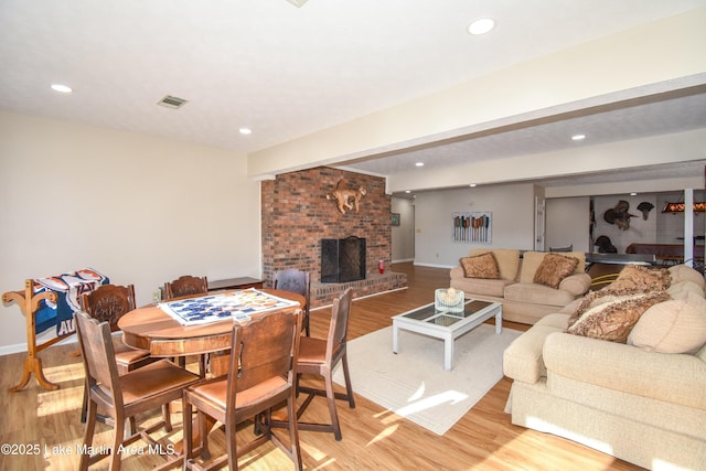 127 Ridge Crest Dr, Jacksons Gap, AL 36861 - living room featuring light wood-style flooring, a brick fireplace, recessed lighting, and baseboards