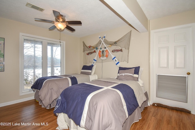 127 Ridge Crest Dr, Jacksons Gap, AL 36861 - bedroom with wood finished floors, baseboards, and multiple windows