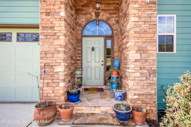 view of exterior entry featuring a garage