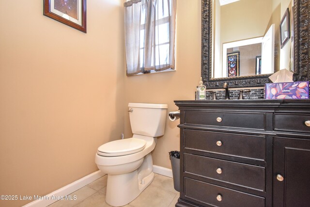 bathroom featuring vanity, tile patterned floors, and toilet