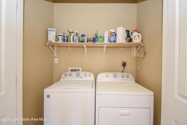 clothes washing area featuring separate washer and dryer