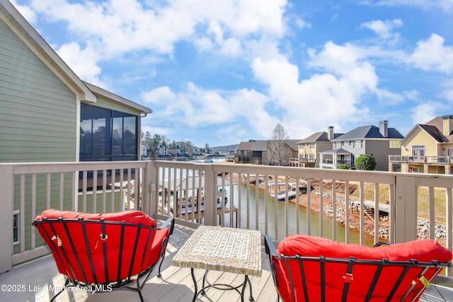 balcony featuring a deck with water view