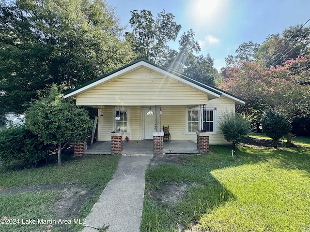 view of front of home featuring covered porch and a front yard