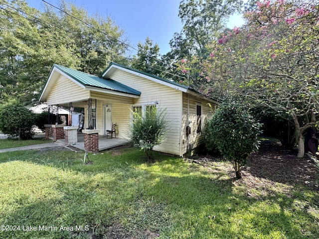 view of front of house with covered porch and a front lawn