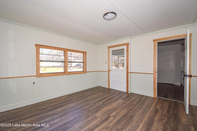 unfurnished room with dark wood-type flooring