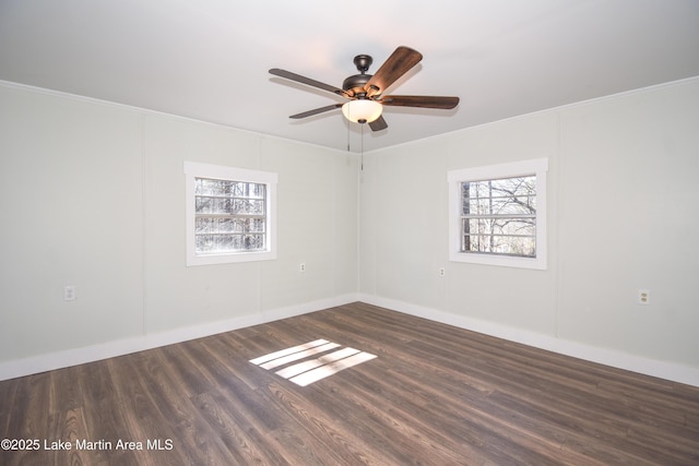 empty room featuring ceiling fan, dark wood-type flooring, and crown molding