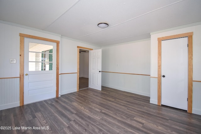 unfurnished room with dark hardwood / wood-style flooring