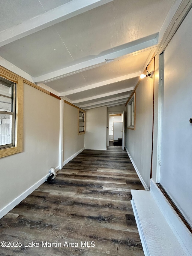 hall featuring beamed ceiling and dark hardwood / wood-style floors