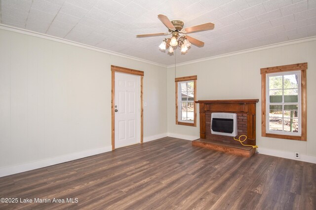 unfurnished living room with a brick fireplace, heating unit, a wealth of natural light, and dark hardwood / wood-style flooring