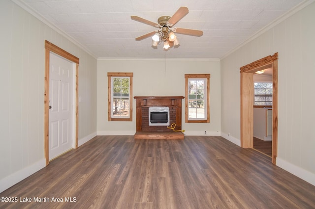 unfurnished living room featuring heating unit, plenty of natural light, dark wood-type flooring, and a fireplace