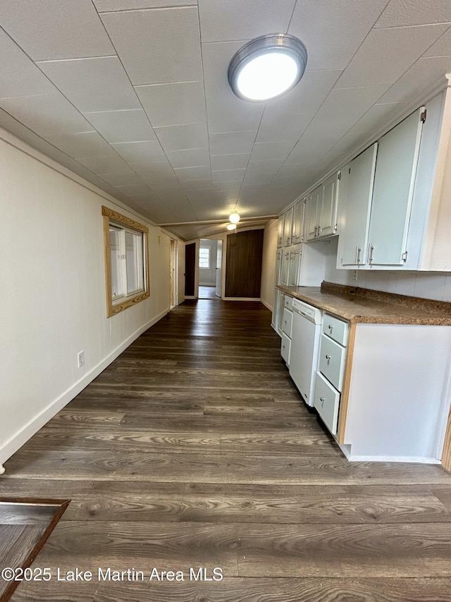 kitchen with dark wood-type flooring, dishwasher, and white cabinets