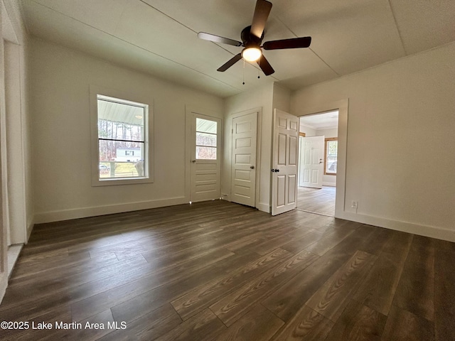 unfurnished room with ceiling fan and dark hardwood / wood-style flooring