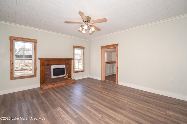 unfurnished living room with heating unit, a brick fireplace, dark hardwood / wood-style floors, and plenty of natural light