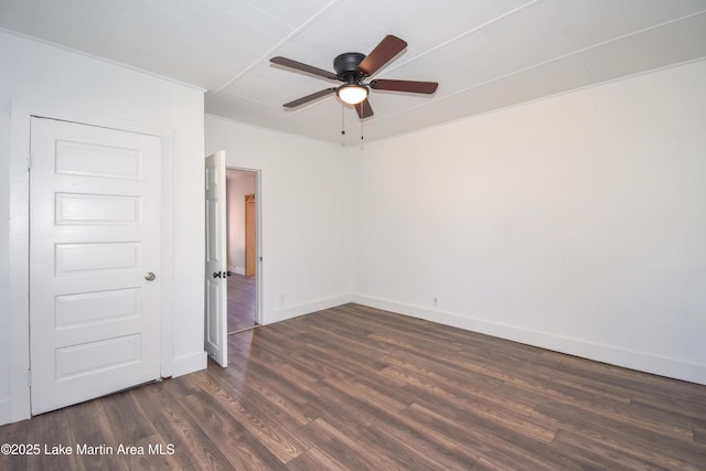 spare room featuring ceiling fan and dark wood-type flooring