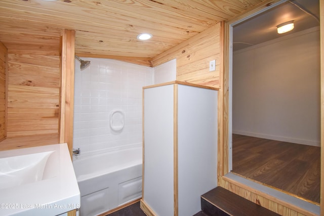 bathroom with tiled shower / bath combo, wood ceiling, and wood-type flooring