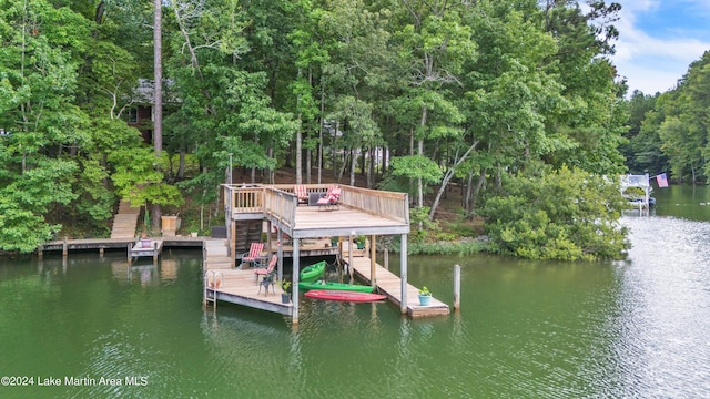 view of dock with a deck with water view