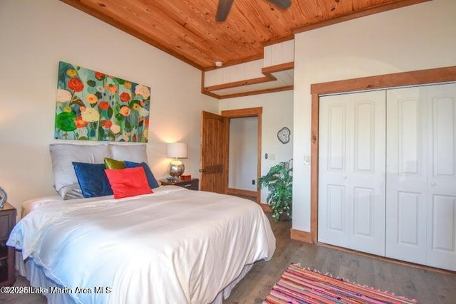 bedroom with dark wood-type flooring, a closet, and wooden ceiling