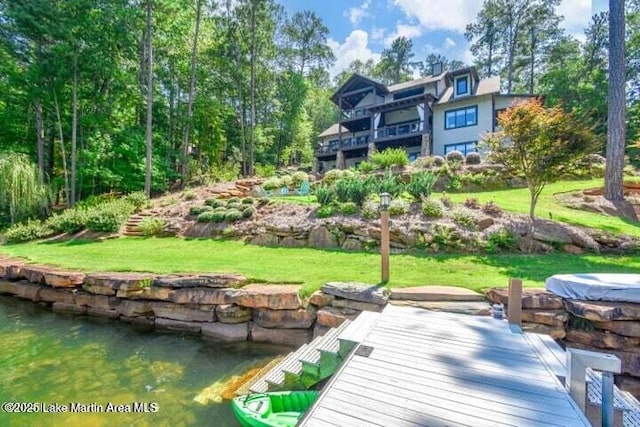 dock area featuring a water view and a yard