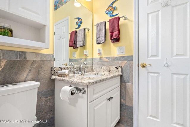 876 Ridge Rd, Dadeville, AL 36853 - half bath featuring tile walls, vanity, and a wainscoted wall