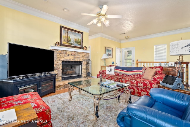 876 Ridge Rd, Dadeville, AL 36853 - living room with ornamental molding, wood finished floors, ceiling fan, and a stone fireplace
