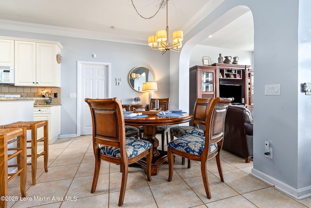 876 Ridge Rd, Dadeville, AL 36853 - dining area featuring arched walkways, ornamental molding, a chandelier, and light tile patterned flooring