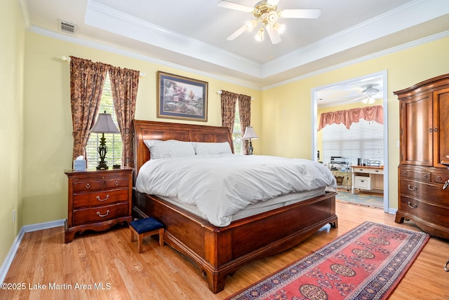 876 Ridge Rd, Dadeville, AL 36853 - bedroom with a tray ceiling, light wood-type flooring, crown molding, and ceiling fan