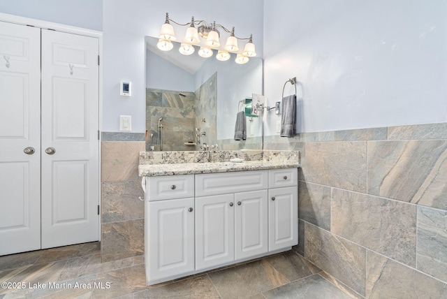 876 Ridge Rd, Dadeville, AL 36853 - full bath with tile walls, vanity, a walk in shower, a wainscoted wall, and vaulted ceiling