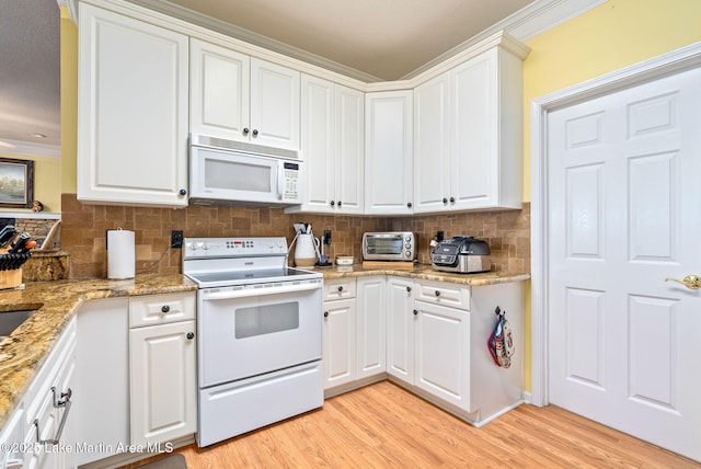 876 Ridge Rd, Dadeville, AL 36853 - kitchen featuring white appliances, light wood-type flooring, decorative backsplash, white cabinetry, and crown molding