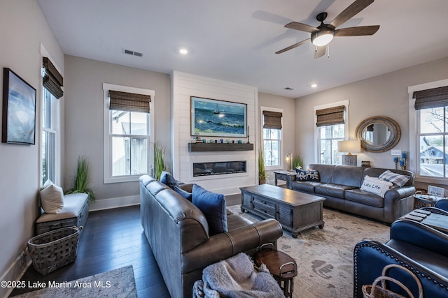 living room with hardwood / wood-style floors, a fireplace, and ceiling fan