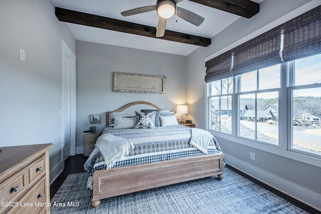 bedroom featuring beamed ceiling and ceiling fan