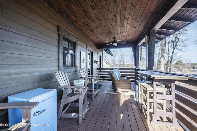 wooden terrace featuring ceiling fan