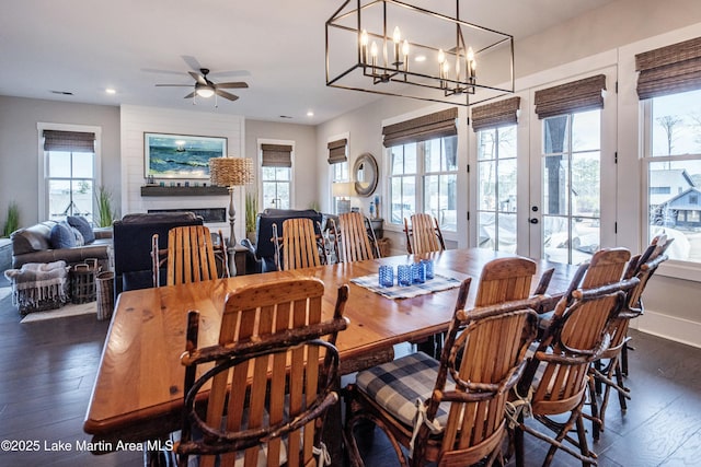 dining room featuring dark wood-type flooring, ceiling fan, a healthy amount of sunlight, and french doors