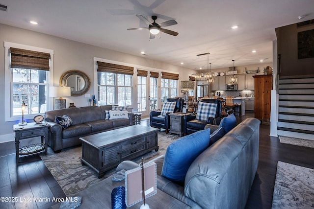 living room featuring ceiling fan and dark hardwood / wood-style flooring