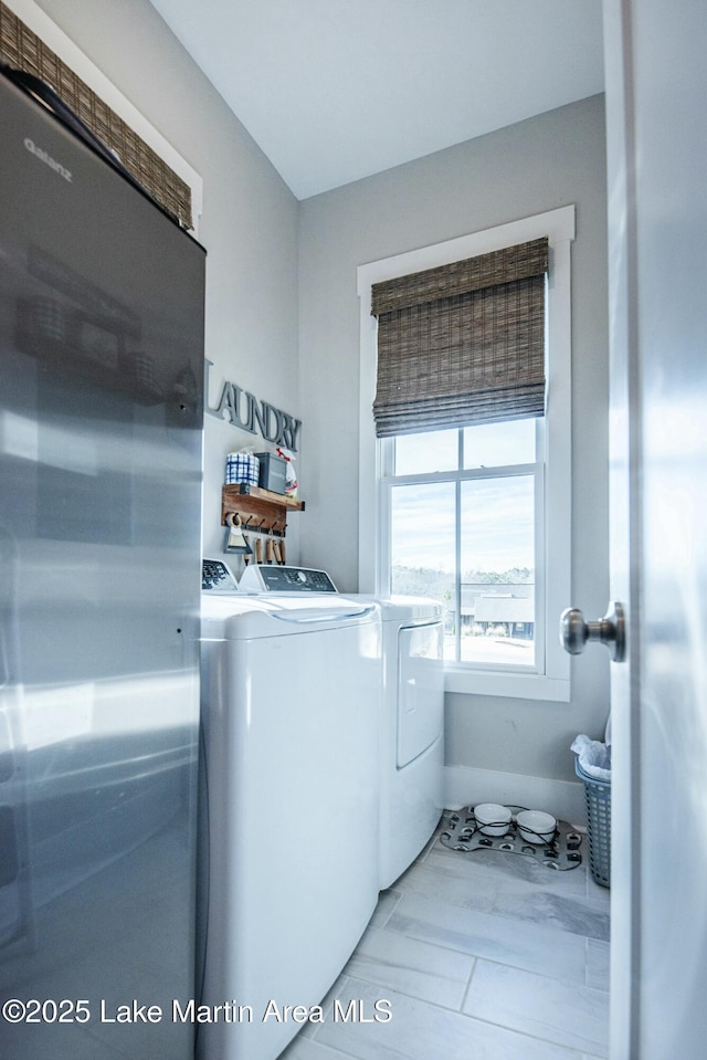 laundry area with washing machine and clothes dryer