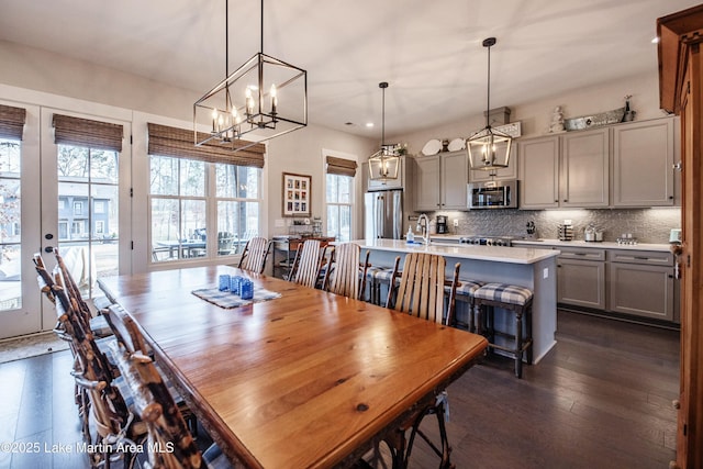 dining room with dark hardwood / wood-style floors and sink