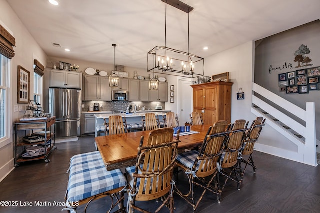 dining room featuring sink and dark wood-type flooring