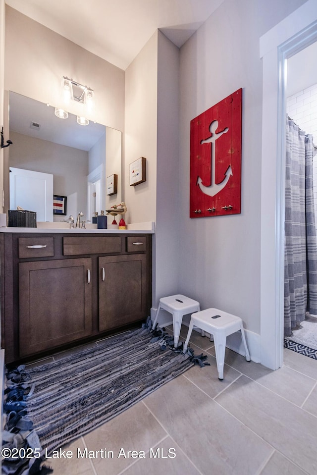 bathroom featuring walk in shower, tile patterned floors, and vanity