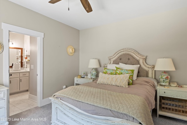 bedroom featuring ensuite bathroom, ceiling fan, and light colored carpet