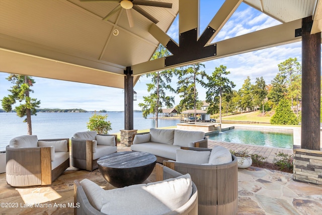 view of patio with an outdoor hangout area, ceiling fan, a swimming pool with hot tub, a gazebo, and a water view