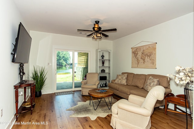 living room featuring ceiling fan and hardwood / wood-style floors