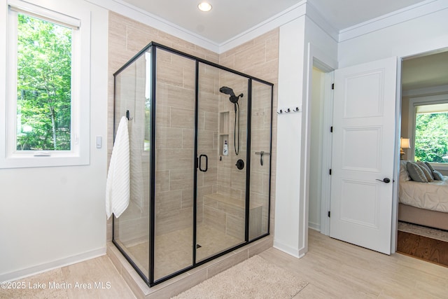 bathroom with crown molding and an enclosed shower