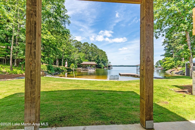 view of yard featuring a water view and a dock