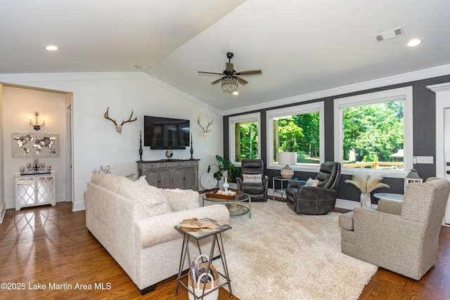 living room featuring vaulted ceiling, ornamental molding, and dark hardwood / wood-style flooring