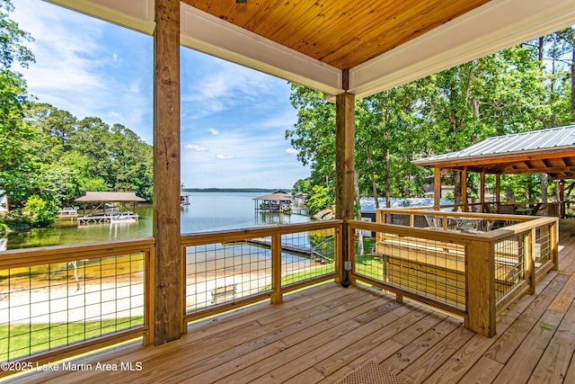 wooden deck featuring a water view and a gazebo