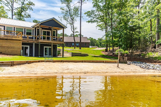 exterior space featuring a water view and a yard