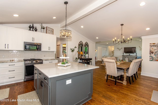 kitchen featuring gray cabinetry, hanging light fixtures, white cabinets, and appliances with stainless steel finishes